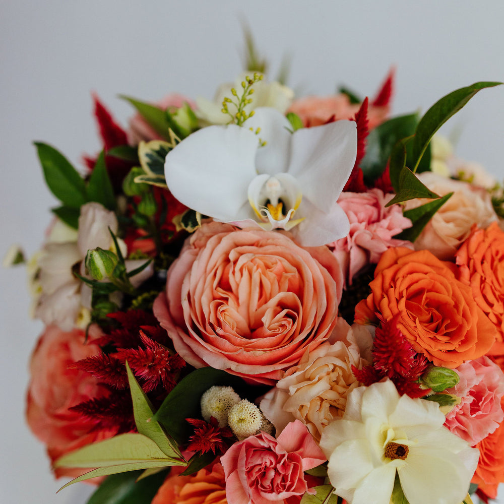 
                  
                    Fall-themed flower arrangement in a glass vase
                  
                