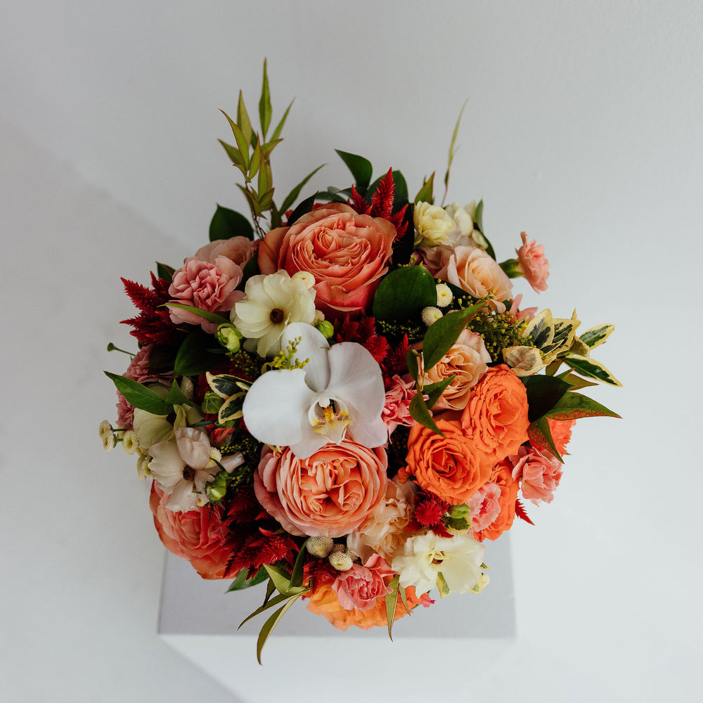 
                  
                    Fall-themed flower arrangement in a glass vase
                  
                