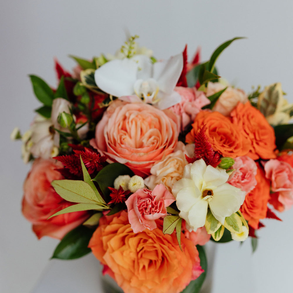 
                  
                    Fall-themed flower arrangement in a glass vase
                  
                
