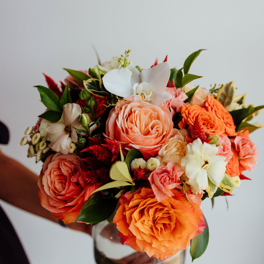 
                  
                    Fall-themed flower arrangement in a glass vase
                  
                