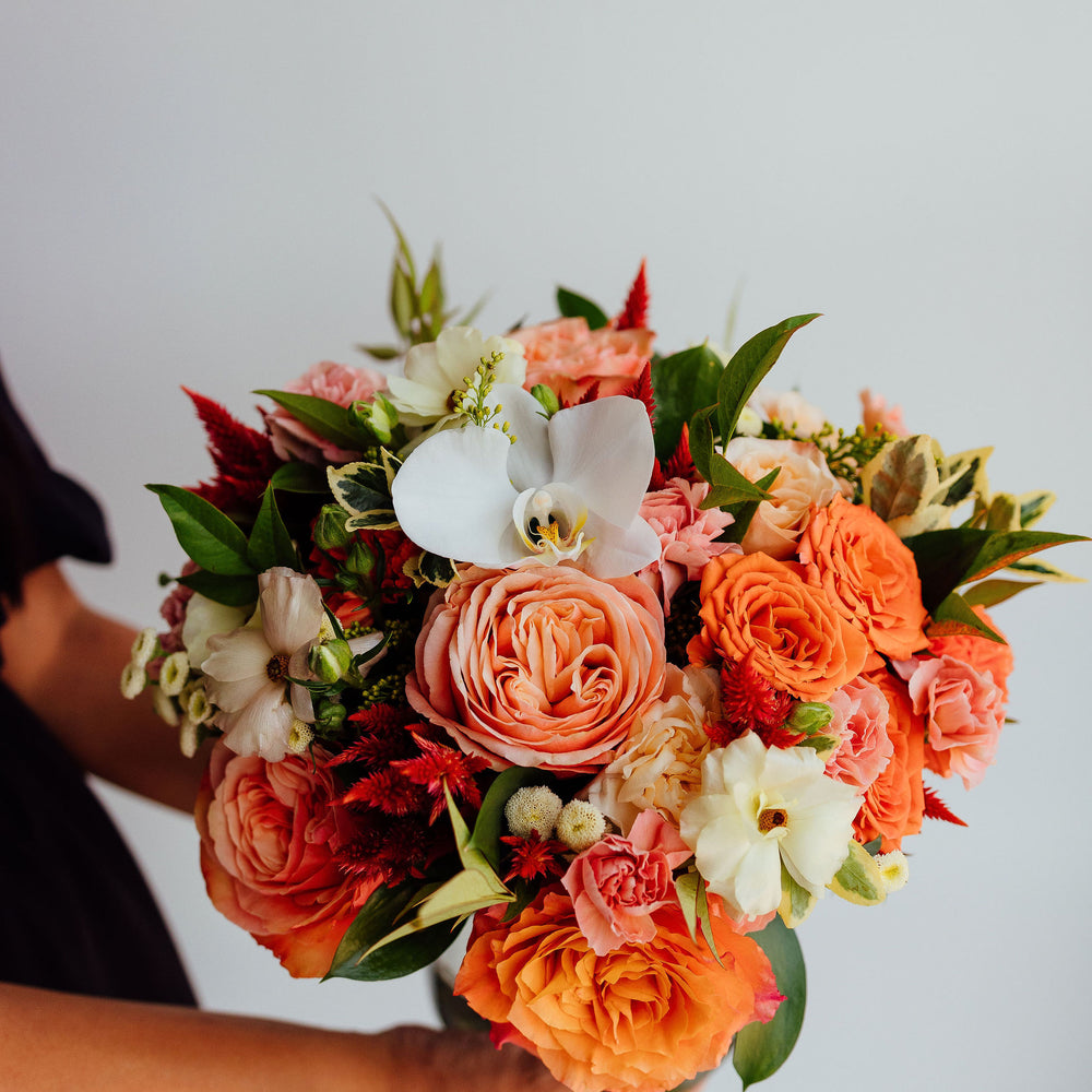 
                  
                    Fall-themed flower arrangement in a glass vase
                  
                